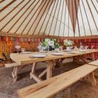One of our super hand crafted tables from the amazing team @barreltopwagons looking lovely in a 24ft yurt.  #yurts #woodenfurniture #weddingfurniture