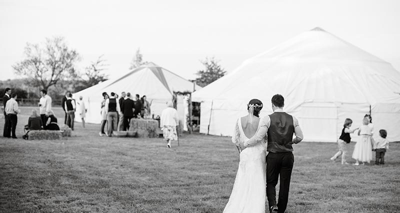Bride and Groom walk to yurt