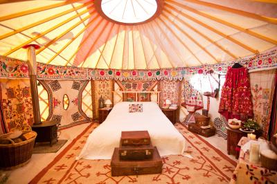 Wood burner in yurt with double bed